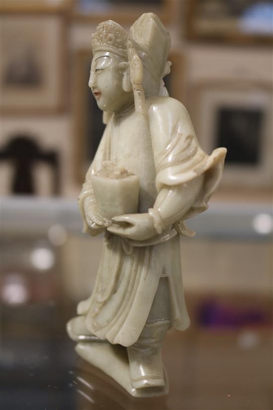 A Chinese soapstone carving of a man holding a jardiniere & other carvings